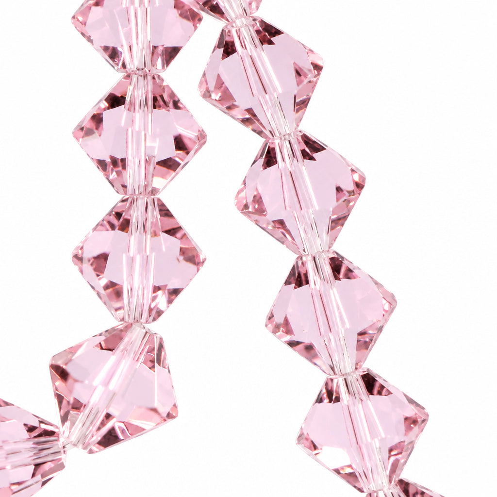 Light pink faceted crystal beads strung together on a cord, shown against a pale light blue background.
