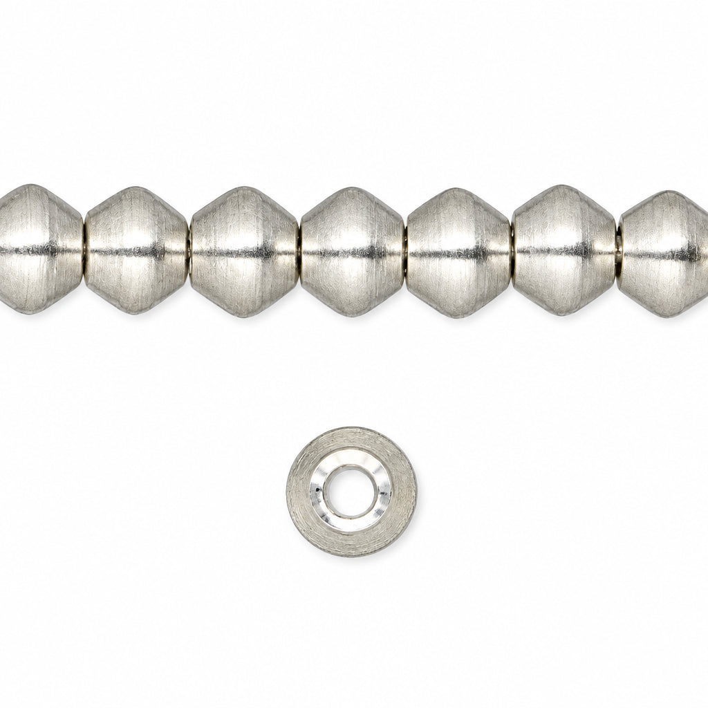 A strand of metallic silver faceted beads with a textured, brushed finish, shown alongside a single matching silver spacer bead on a plain white background.
