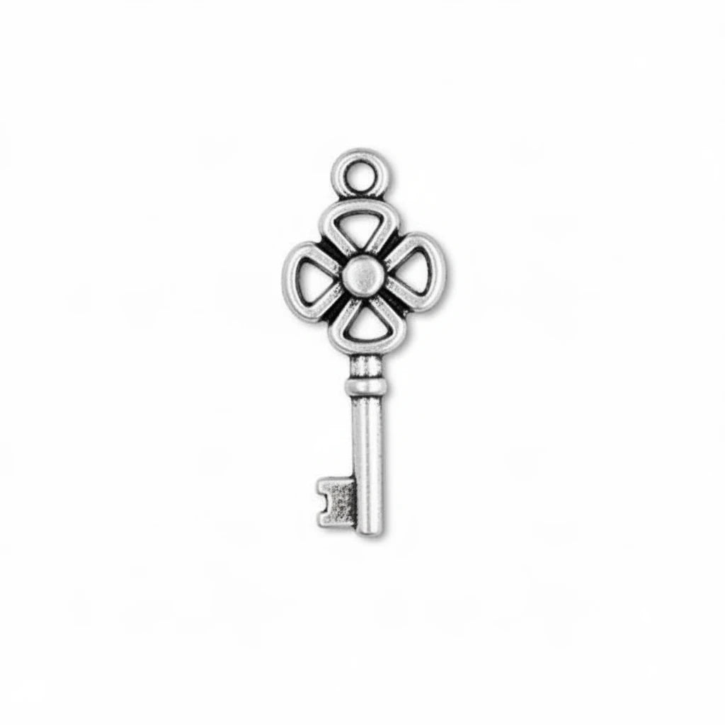 A single silver-toned metal key-shaped charm with an ornate four-petal top and a hanging loop, shown on a plain white background.