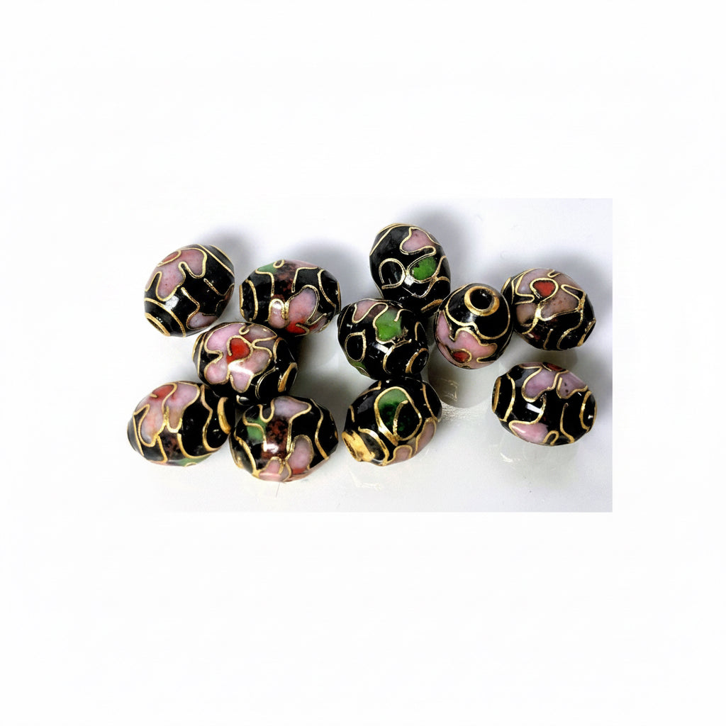Decorative beads with black, gold, pink, and green colors on a white background