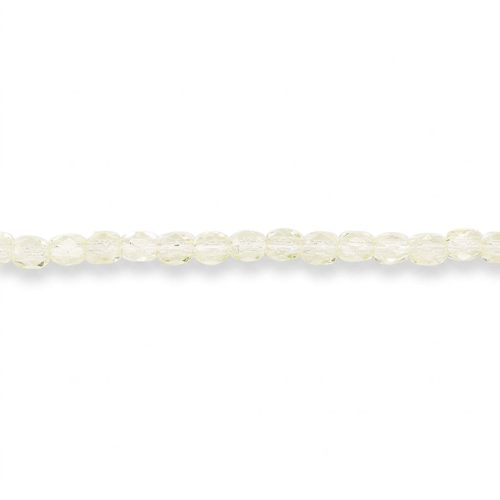 A single strand of faceted round beads in a pale yellow color, laid horizontally against a solid white background.