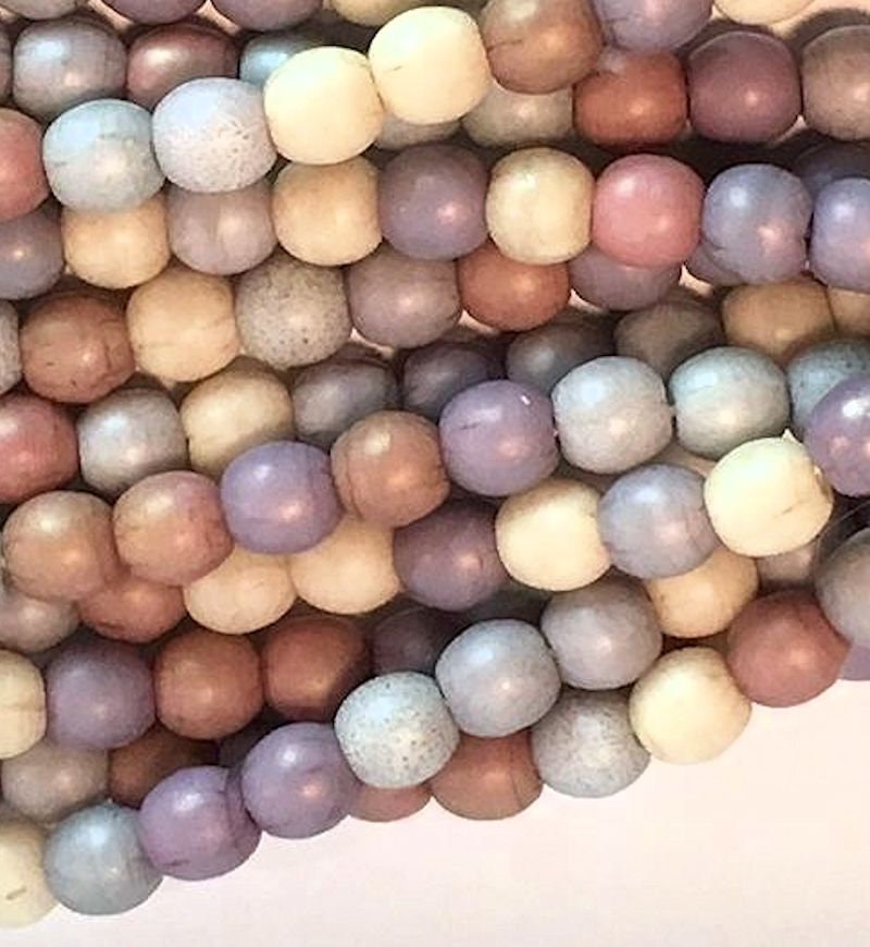 Close-up of multicolored beads on a white background