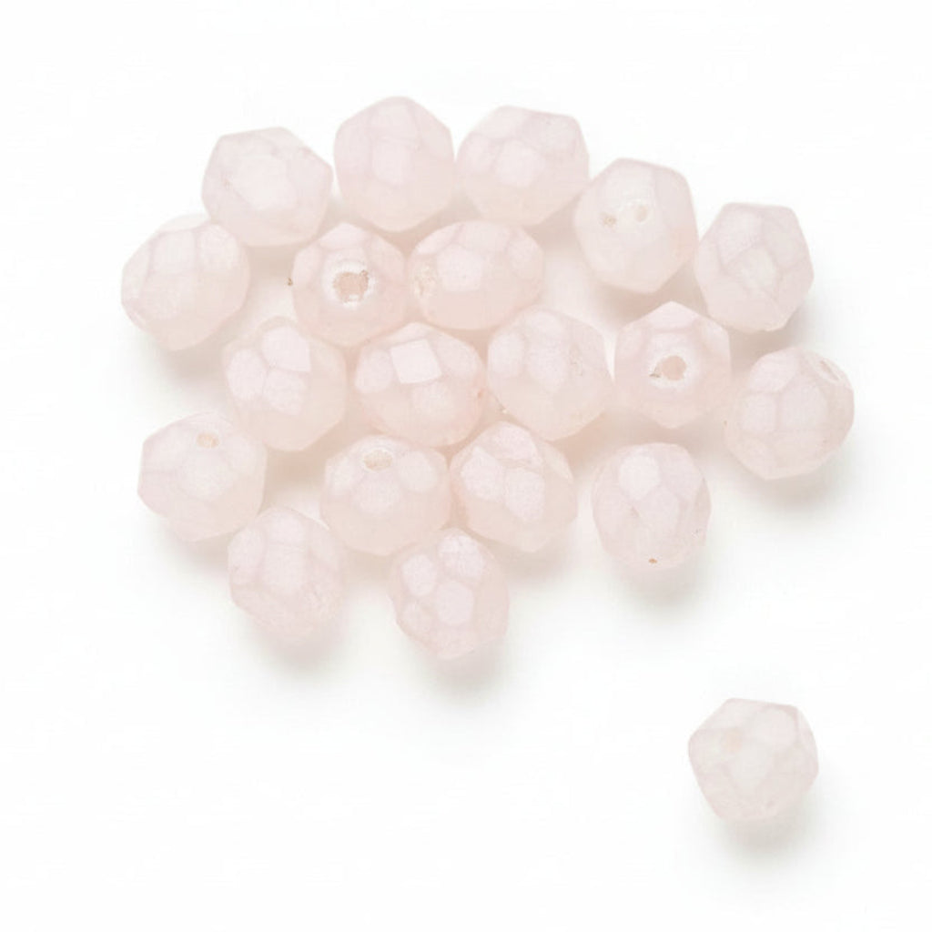 A pile of pale pink faceted round beads on a white background, with two small empty bead shapes shown at the bottom right.