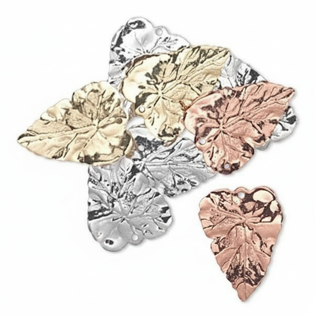 Five metallic leaf-shaped jewelry findings in gold, silver, and rose gold tones, arranged on a plain white background.