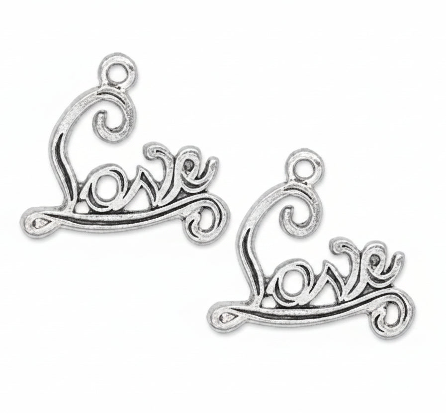 Two silver-toned metal charms shaped like stylized cursive script reading 'love' with decorative swirls at the top, shown on a plain white background.