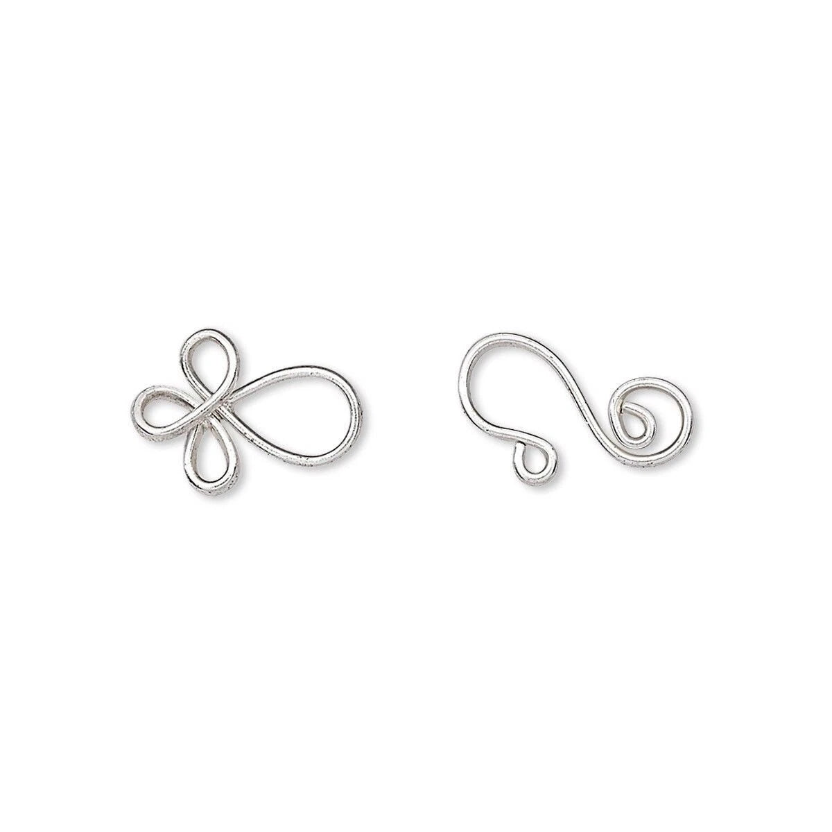 A pair of silver wire ear cuffs shaped like stylized infinity loops, displayed on a clean white background.