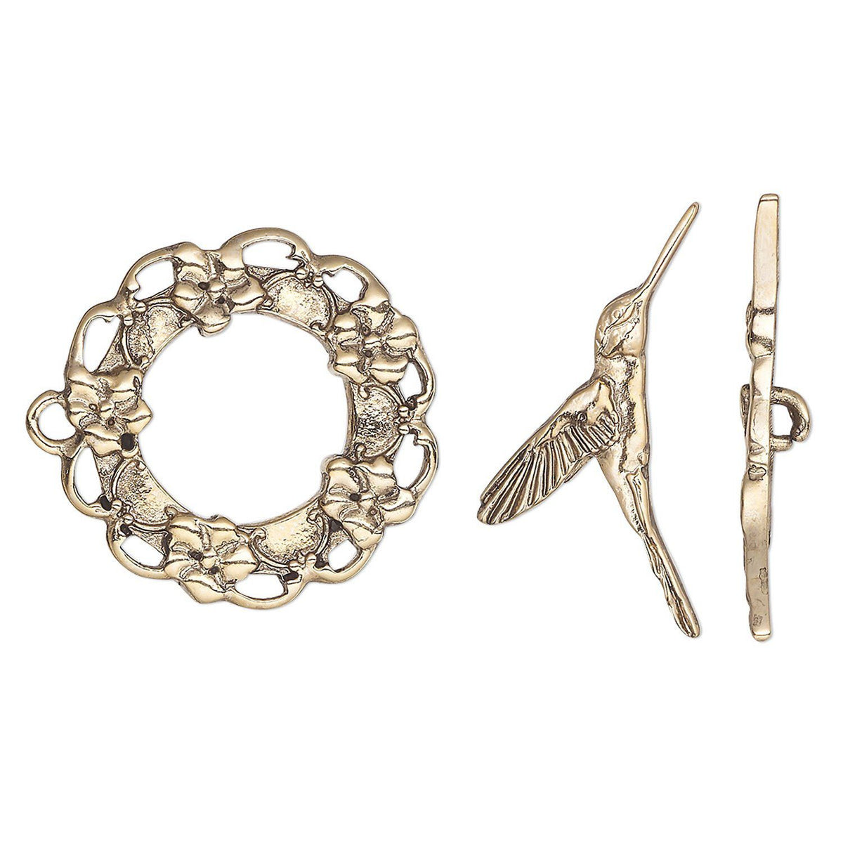 A vintage-style toggle clasp set featuring a circular wreath-shaped charm with floral details, a hummingbird figure charm, and a flat bar, all in an antique gold finish on a white background.