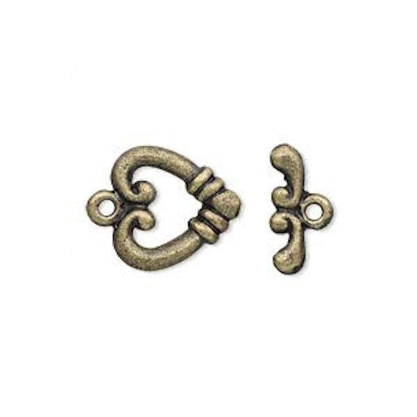 Two ornate antique bronze jewelry findings,