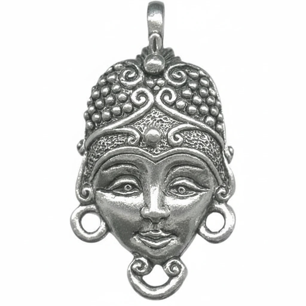 An ornate silver pendant featuring a stylized face with detailed filigree patterns, circular earrings, and a top bail, shown on a plain white background.