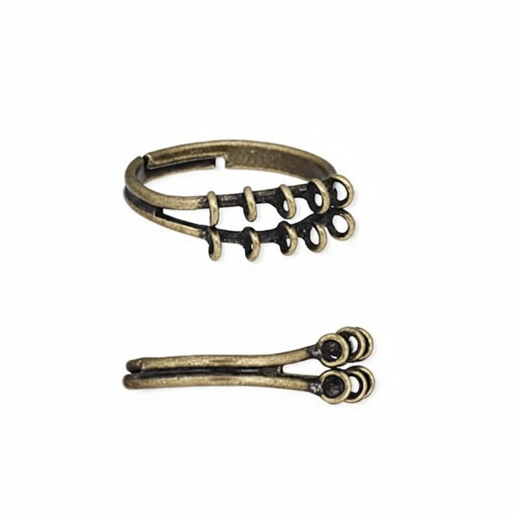 Two small antique bronze metal findings, likely for jewelry making, shown on a plain white background. The top piece has a looped band with several small spiral or coiled prongs.