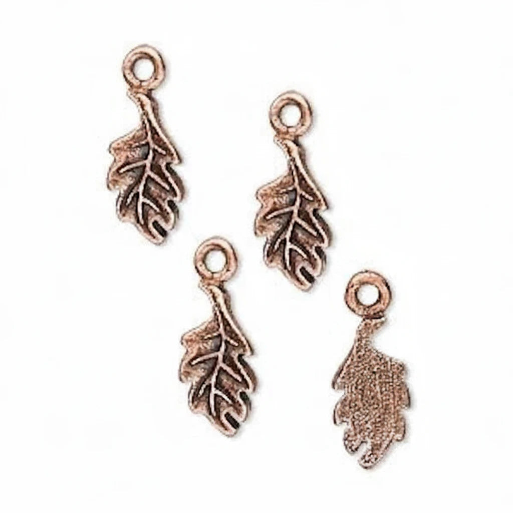 Four antique bronze leaf-shaped jewelry charms with loop tops, arranged on a plain white background.
