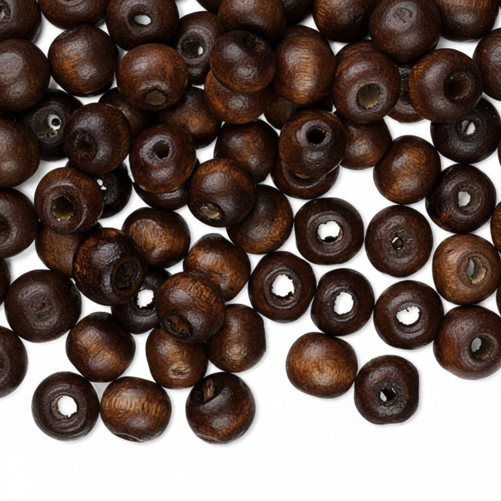 Dark brown wooden beads with natural wood grain and central holes, scattered on a white background.