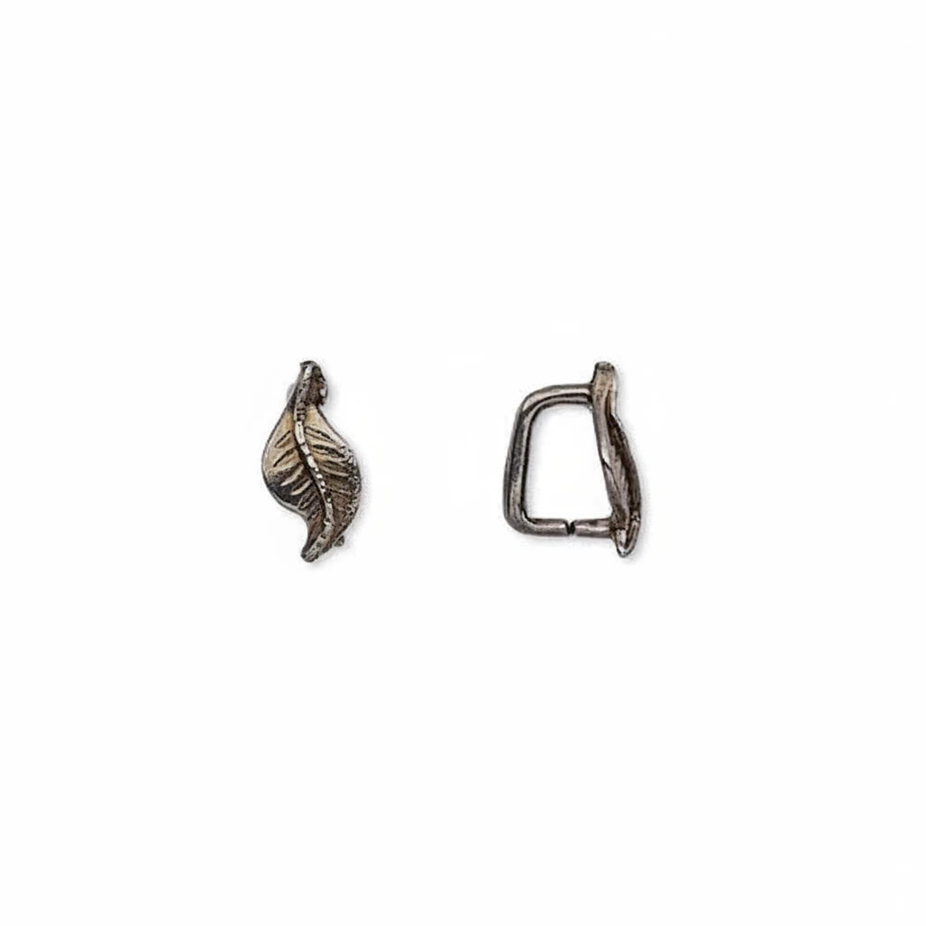 Two small metallic jewelry findings on a plain white background, one shaped like a leaf and the other like a small loop or clasp, both in an antique silver finish.