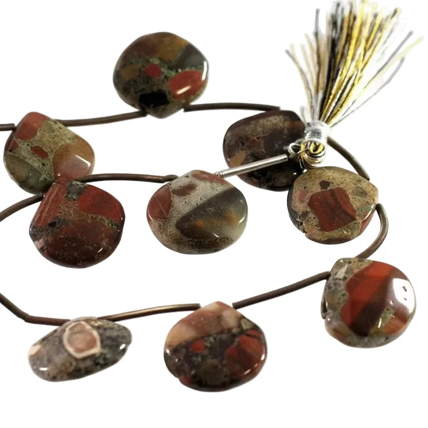 A strand of polished agate stone beads with natural red, brown, and green patterns, strung on a dark cord with two decorative tassels, photographed on a white background.