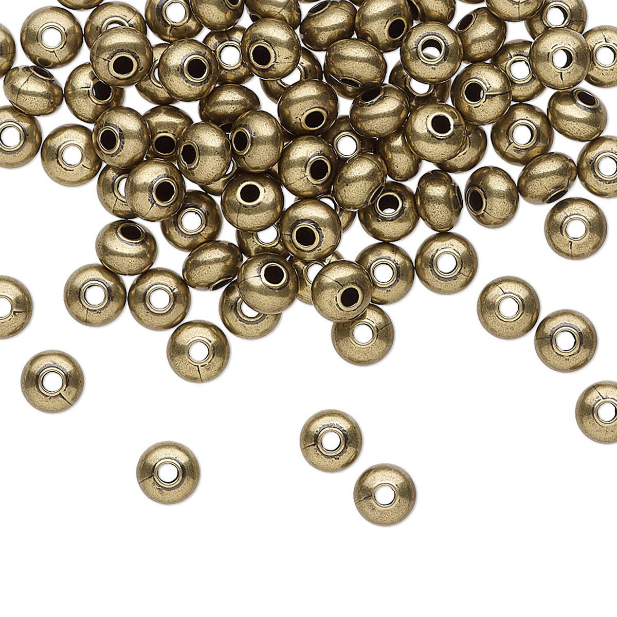 Metallic bronze round craft beads with central holes, scattered on a plain white background.