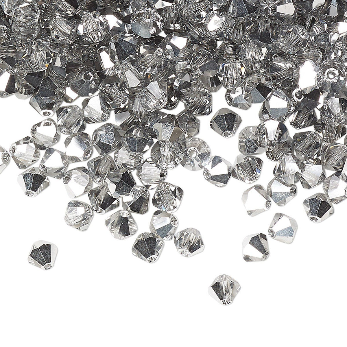 A pile of clear faceted crystal beads scattered on a white background, with a few beads lying outside the pile.