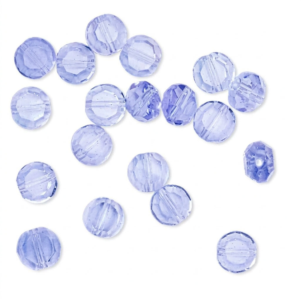 Light blue faceted round beads scattered on a plain white background.