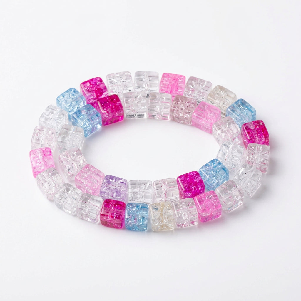 A set of GLASS beads with colorful segments in pink, blue, and white, arranged on a plain white surface.