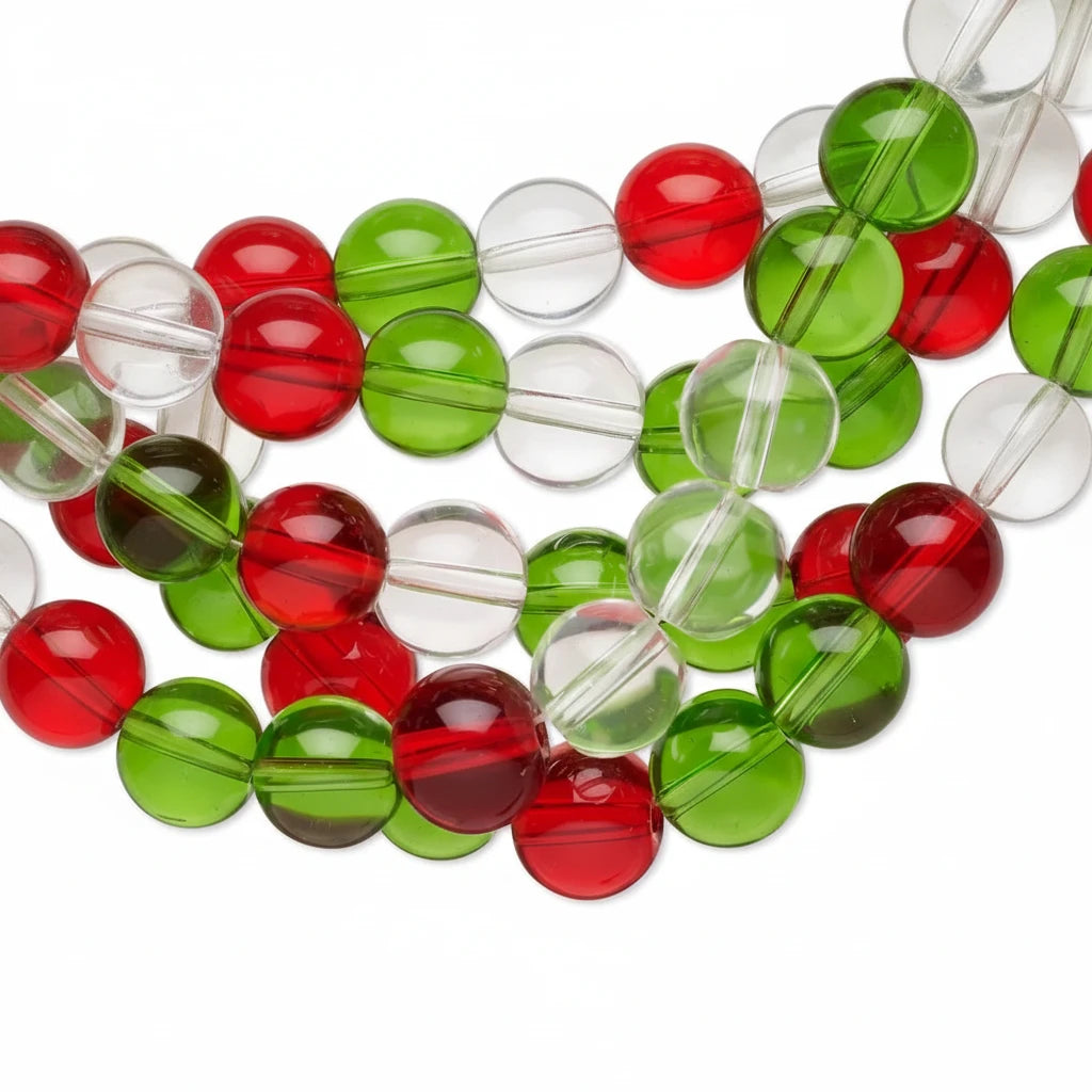 Clear round glass beads with red and green color bands, arranged in a close-up diagonal pattern on a white background.