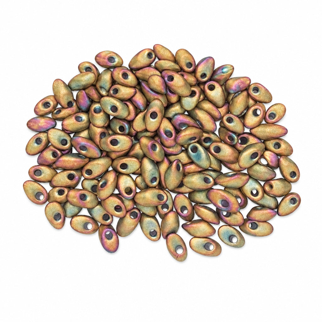 A pile of small oval beads with a metallic iridescent finish, showing bronze, gold, and purple hues, on a plain white background.