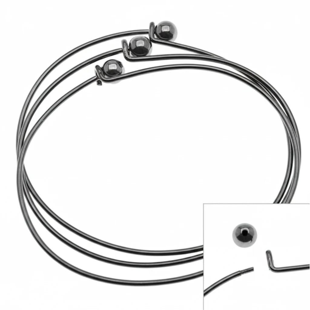 Three thin black metal wire bangles with ball closures, shown on a white background with a small inset detail of the closure mechanism.