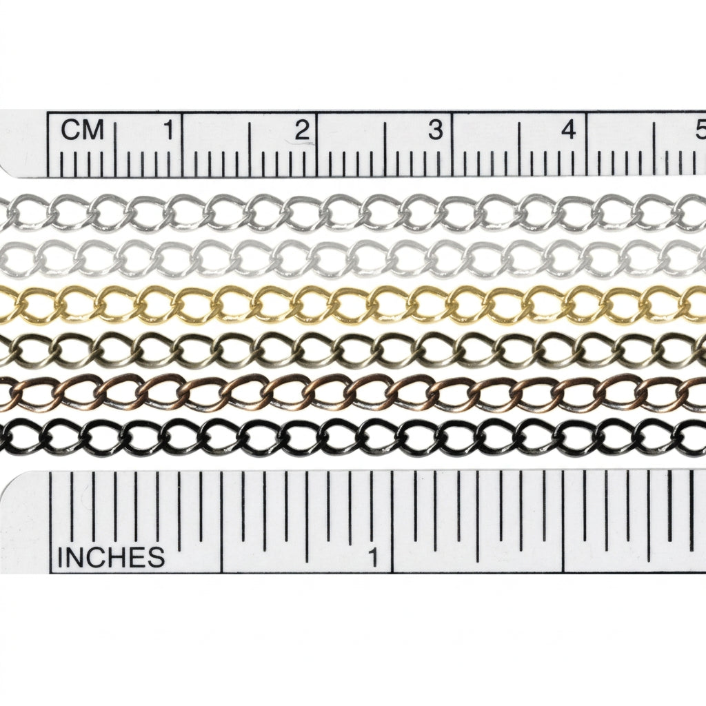 Four metal chain strands in silver, gold, bronze, and black, shown in a close-up with ruler markings above and below for centimeter and inch measurements.