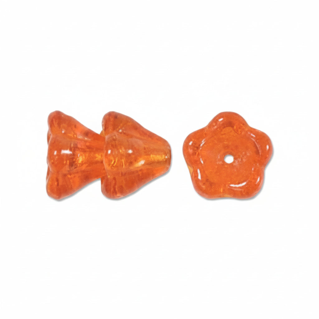 Two small translucent orange beads on a plain white background, one with a pointed fish-like shape and the other with a flower-like circular shape.