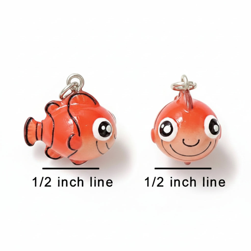 Two small orange fish-shaped charms with silver loops at the top, shown side by side on a white background with black measurement lines and text reading 1/2 inch line.
