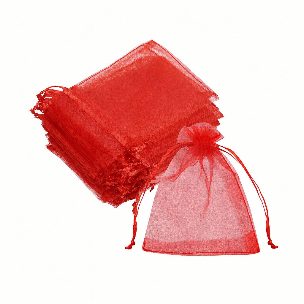 A stack of red organza drawstring pouches with one pouch shown open in front, photographed on a plain white background.