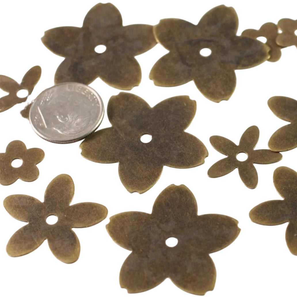 A set of dark brown flower-shaped craft beads or pendants with a single center hole, shown on a white background with a silver coin for scale.