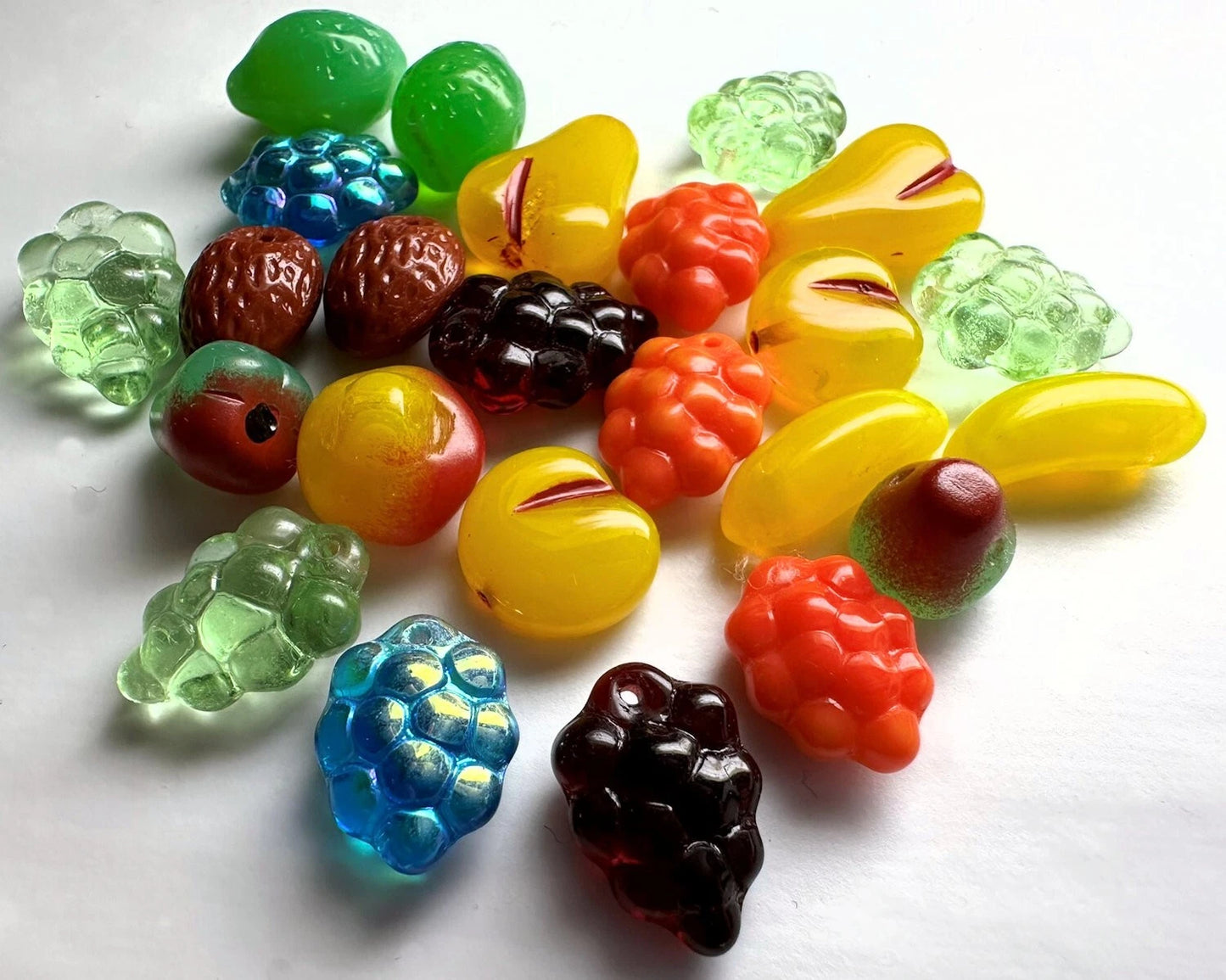 Assorted colorful gLASS BEADS on a white background