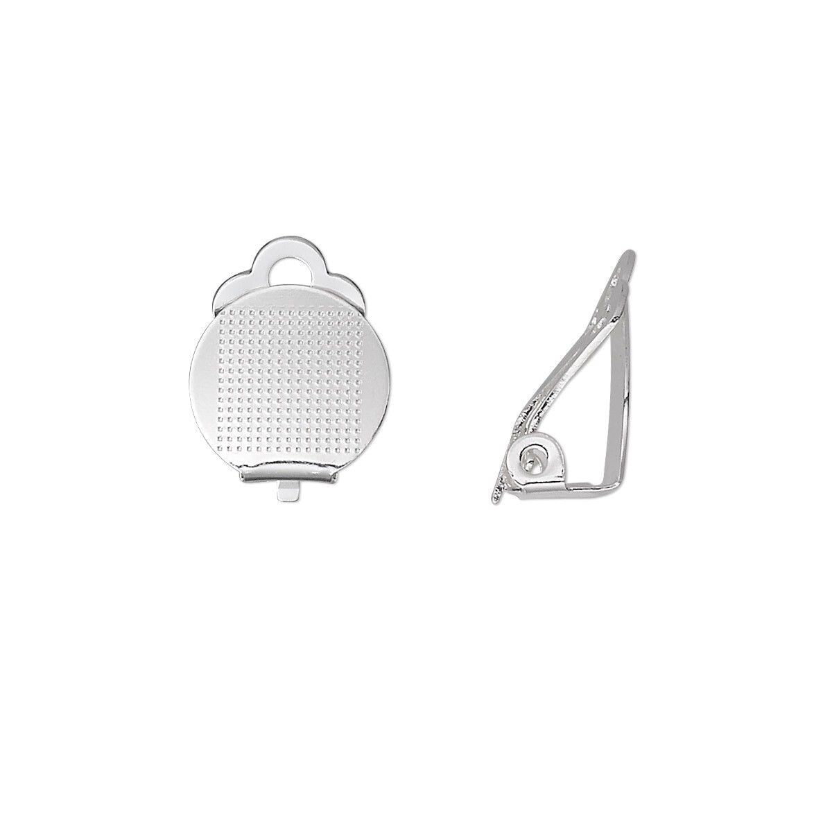 A pair of silver-toned metal ear cuffs shown on a plain white background, one displaying the textured circular face and the other showing the side profile.