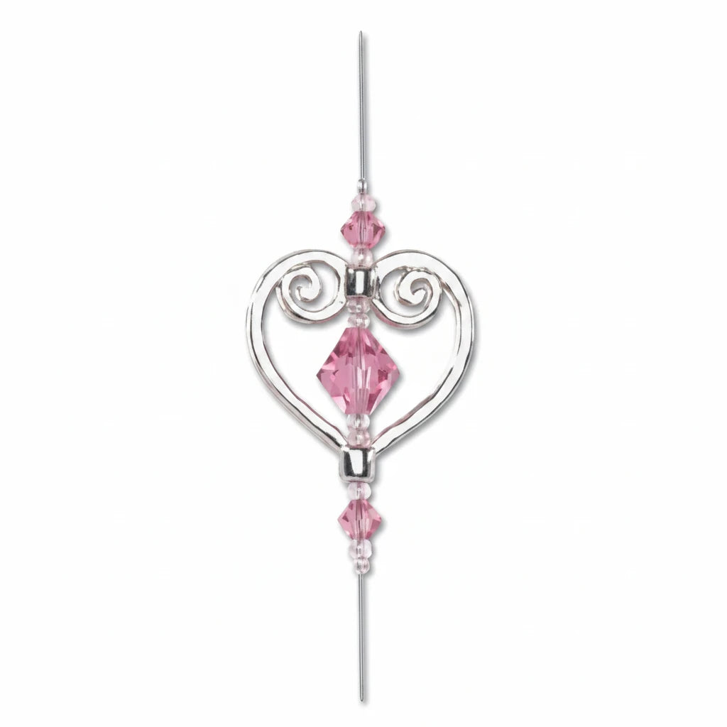 A silver-toned heart-shaped hanging ornament with pink faceted crystal beads, shown on a plain white background with a 'SAMPLE USE NOT INCLUDED' text overlay at the bottom.