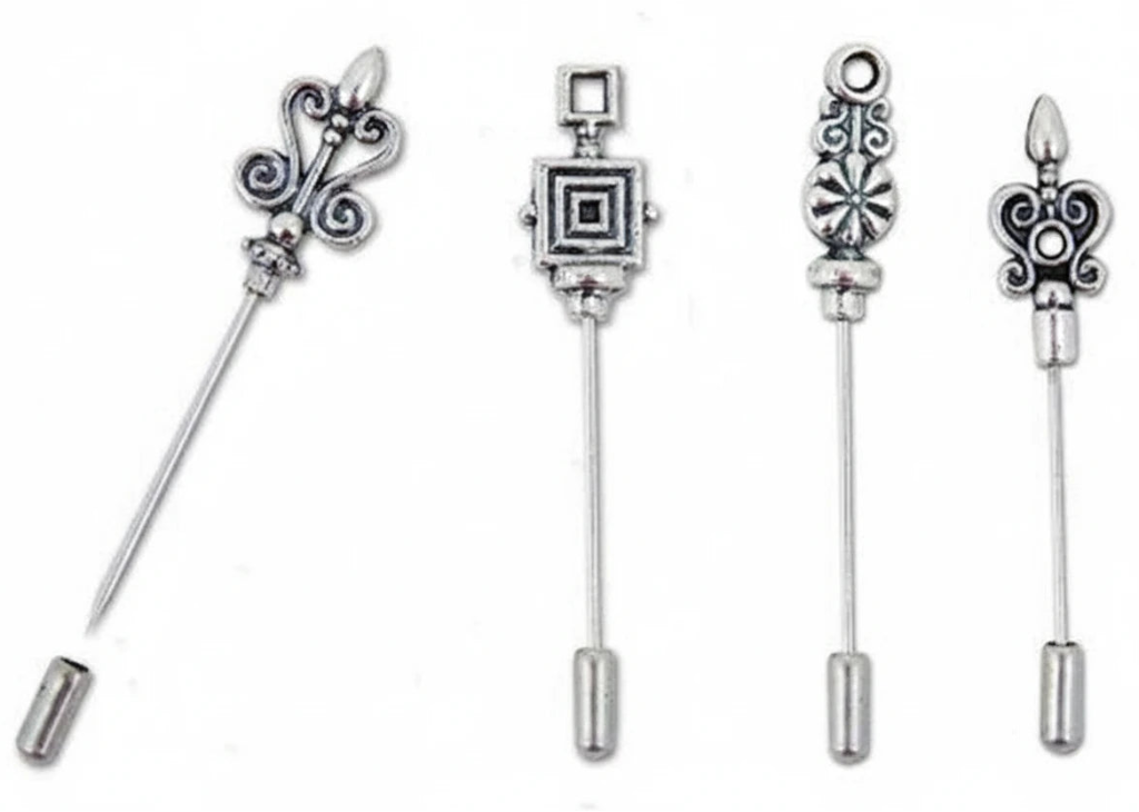 Four silver-toned decorative safety pin backings with ornate filigree and geometric designs, displayed on a plain white background.