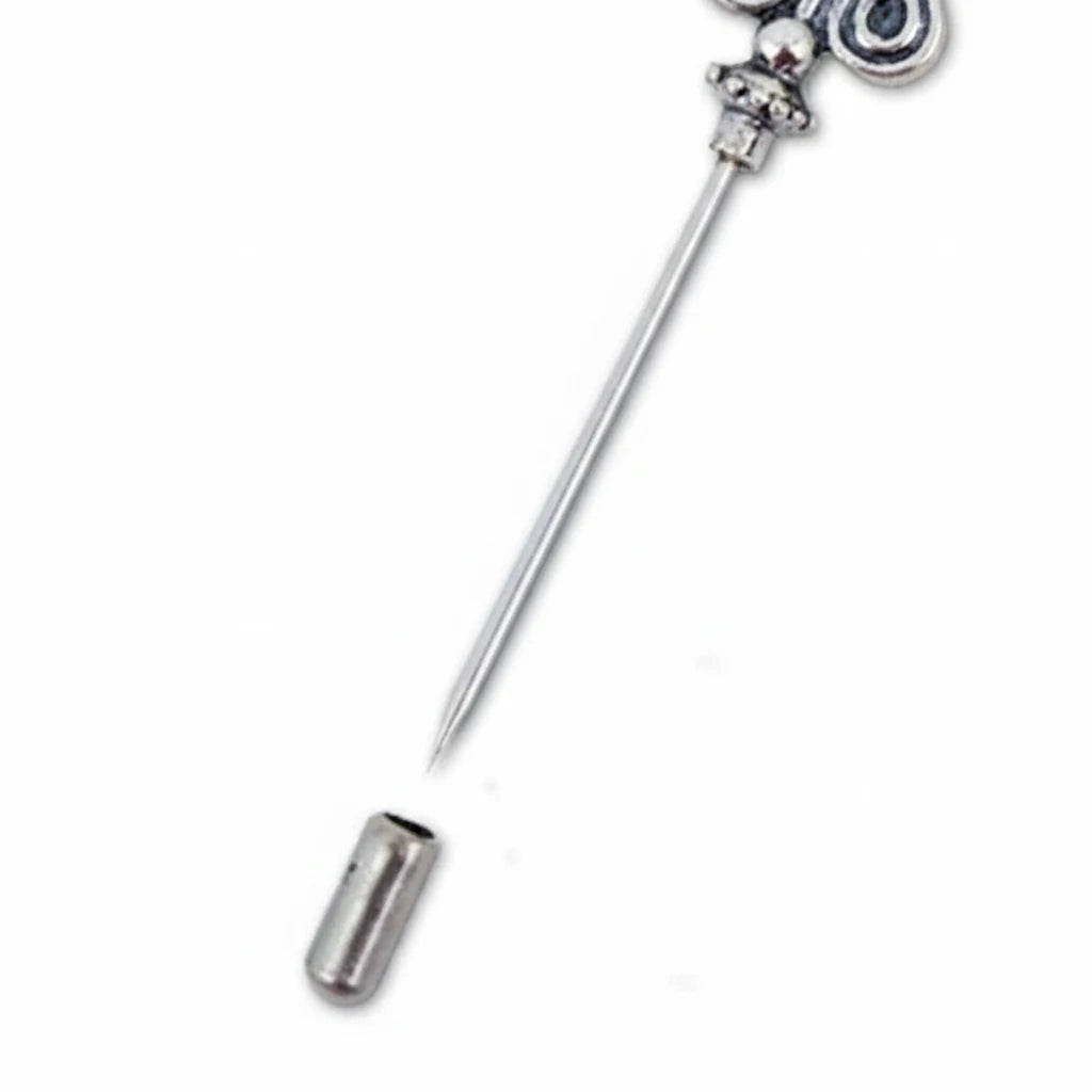 A silver-toned metal tongue scraper with a long straight handle, decorative top, and a separate cylindrical scraper head shown below on a plain white background.