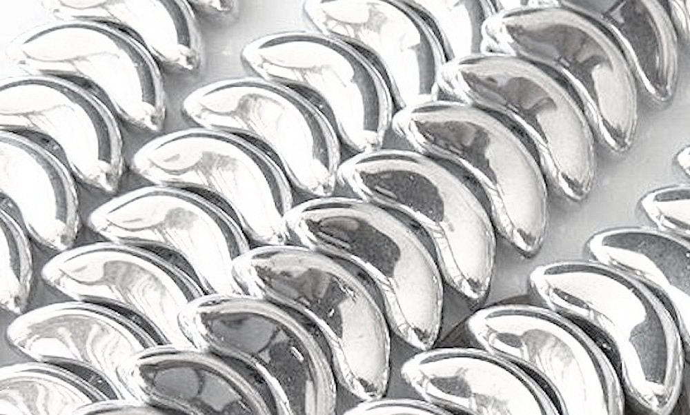 Close-up of silver metallic wing-shaped beads.