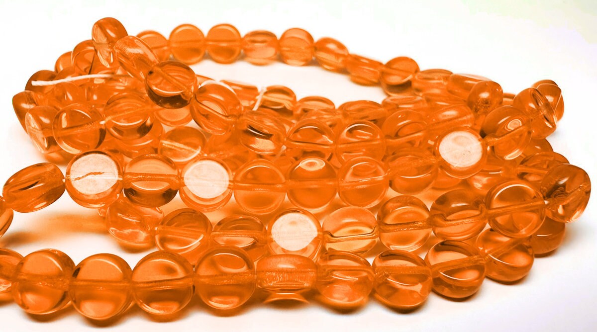 Orange glass beads on a white background