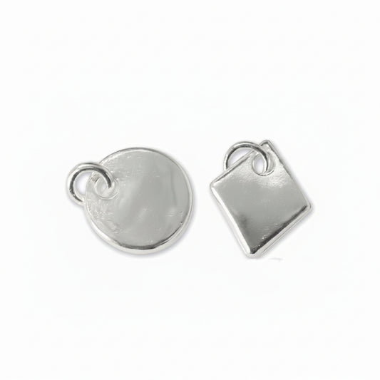 Two silver metal jewelry charms, one round disc and one square, each with a small loop at the top, shown on a plain white background.