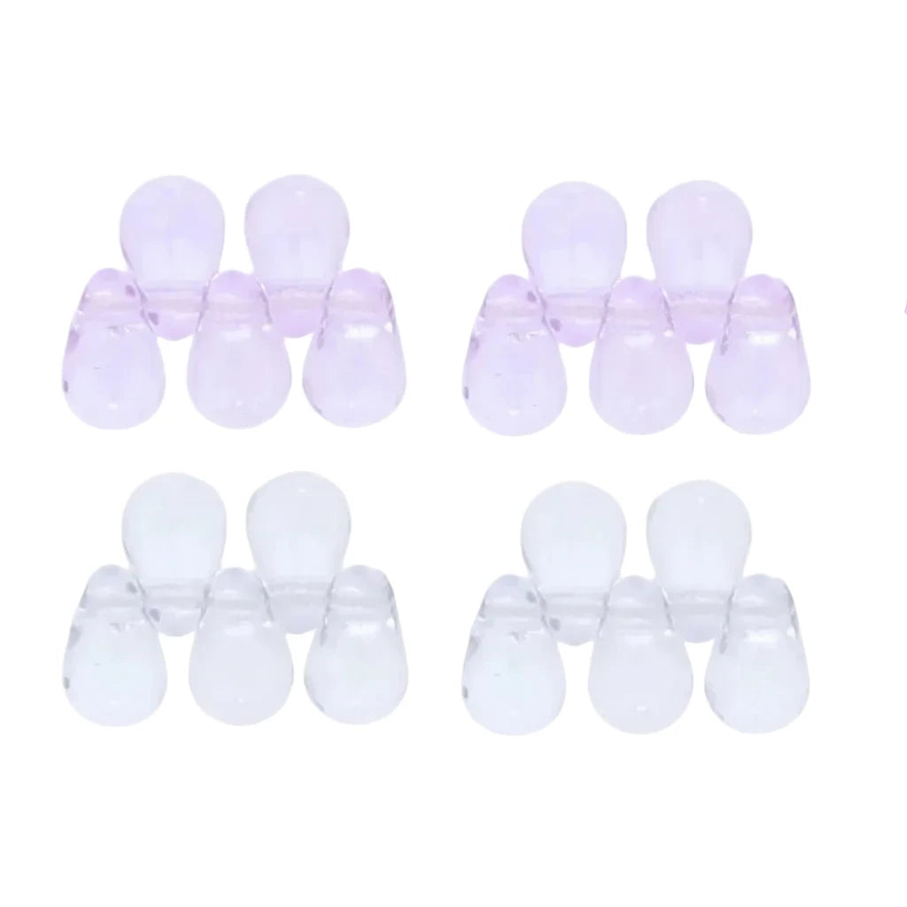Six pairs of translucent silicone or plastic bead caps, shown in two color options: light lavender purple and clear/white. The beads are arranged in two rows of three on a plain white background.