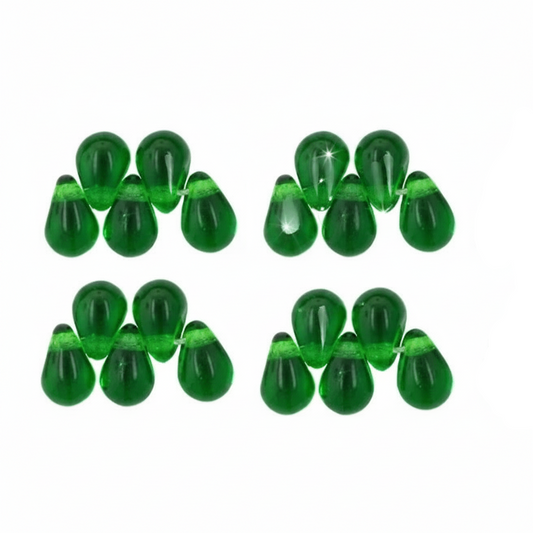 Six pairs of glossy green teardrop-shaped beads strung on thin white cords, arranged in a grid on a plain white background.