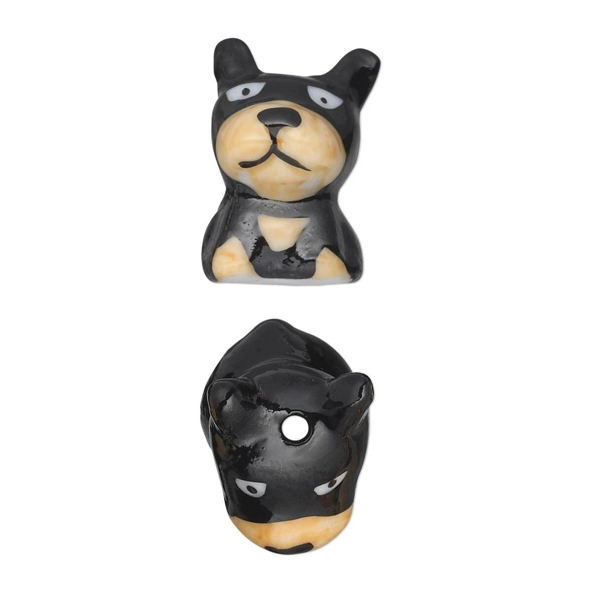 Two small glossy black and cream dog-shaped beads shown on a plain white background, one from the front and one from the back.