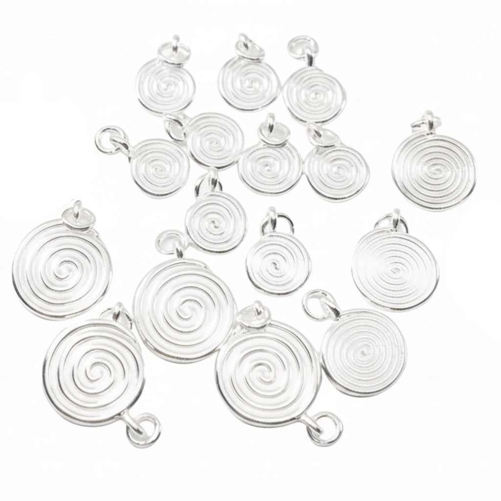 Multiple silver spiral pendant charms arranged on a white background, 