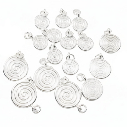 Multiple silver spiral pendant charms arranged on a white background, 