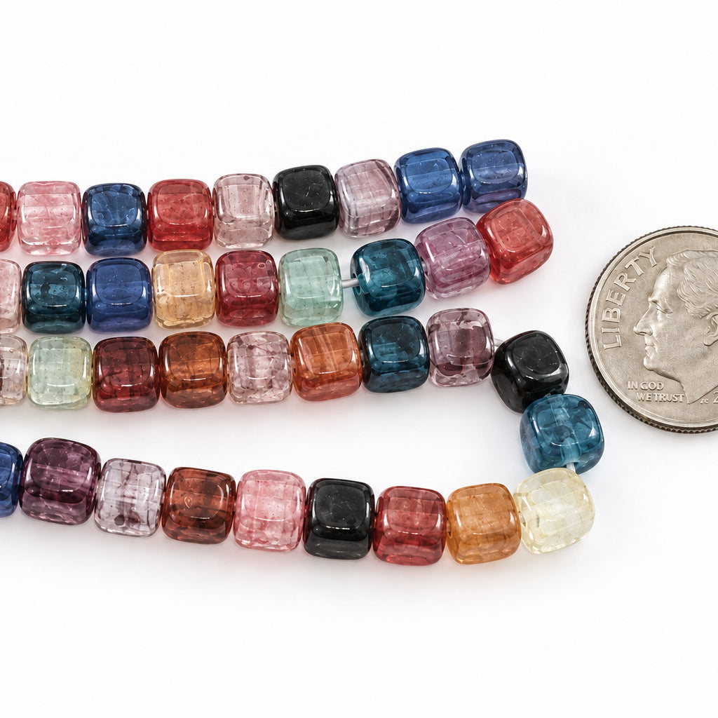 A strand of colorful  CUBE beads in various colors and patterns, shown next to a US quarter for scale, with the text 'The Mystical Garden Path' at the bottom.