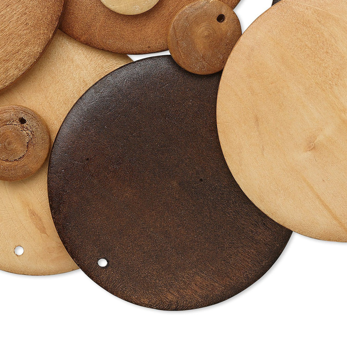 A close-up arrangement of round wooden discs in multiple natural wood tones, including dark brown, tan, and light beige, with small holes visible in some pieces, set against a white background.