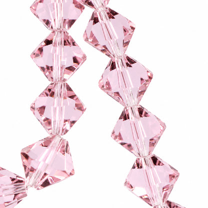 Light pink faceted crystal beads strung together on a cord, shown against a pale light blue background.