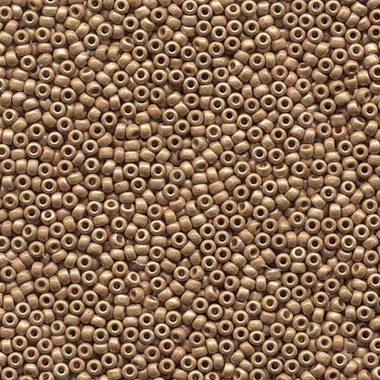 A dense, close-up pile of small metallic bronze cylindrical beads with central holes, filling the entire frame.