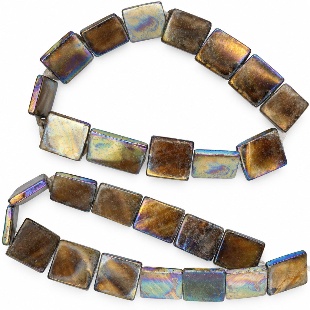 Square iridescent beads with a metallic gold, bronze, and purple shimmer, arranged on a plain white background.