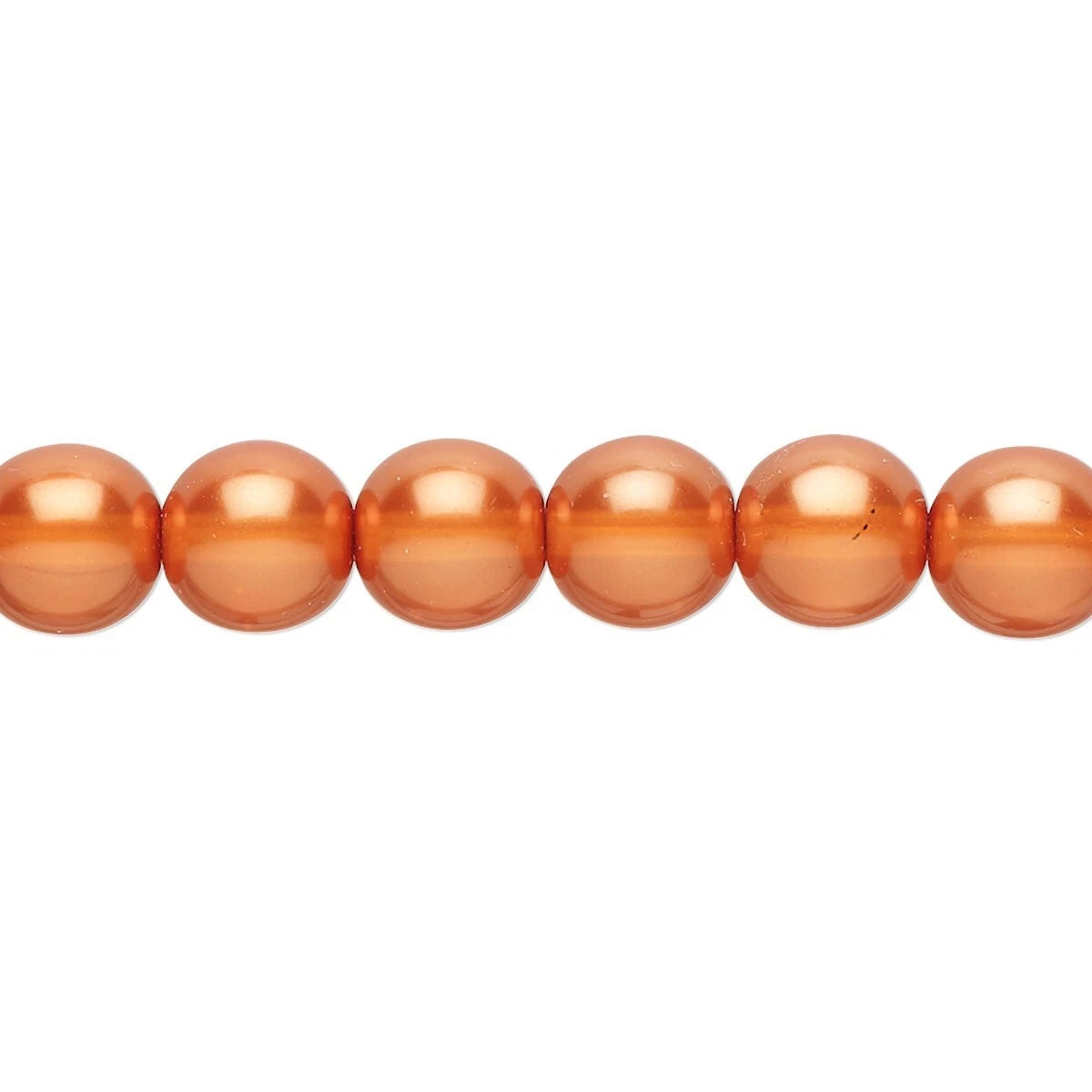 A close-up of glossy, round peach-orange beads strung horizontally on a white background.