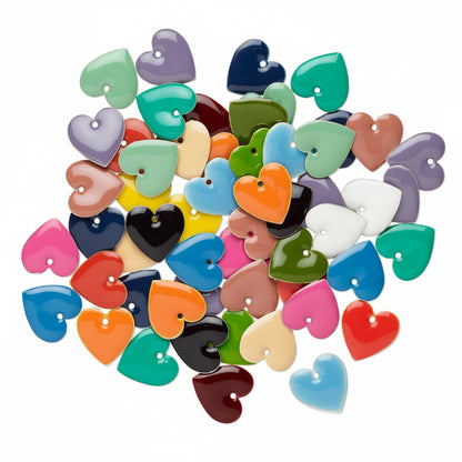 A pile of small heart-shaped glossy beads in assorted colors, including blue, green, pink, orange, purple, red, black, and beige, arranged on a plain white background.